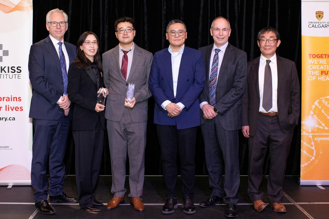 A group of people stand together in a line